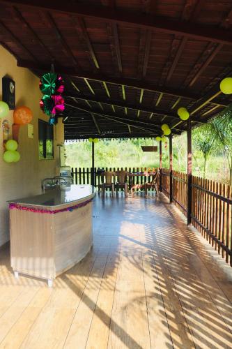 a patio with a bar on a deck at 1000 SILVERS -Farm Stay in Mysore