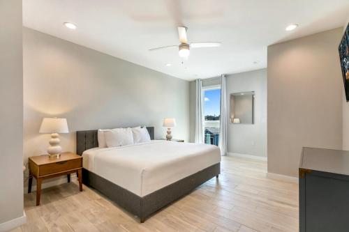 a bedroom with a bed and a table with two lamps at Private Townhouse in a Secure Location in New Orleans