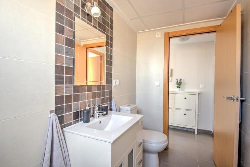 a bathroom with a sink and a toilet at Apartment BlueHat Moncofa in Moncófar