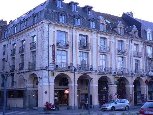 a large building on the corner of a street at LES ARCADES in Dieppe