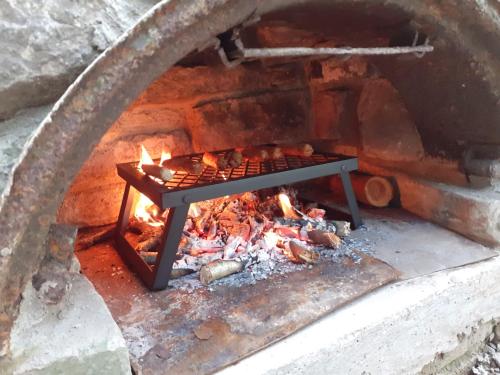 a brick oven with a fire in it at Oakdean Cottage Yurt in Blakeney