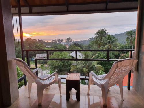 two chairs and a table on a balcony with a view at Life koh tao resort in Koh Tao