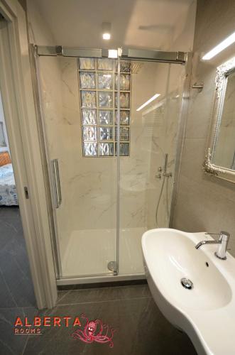 a bathroom with a shower and a white sink at ALBERTA Rooms Manarola in Manarola