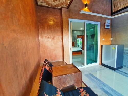a living room with a couch and a sliding glass door at Life koh tao resort in Koh Tao
