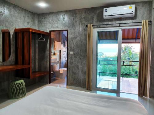 a bedroom with a bed and a view of a bathroom at Life koh tao resort in Koh Tao