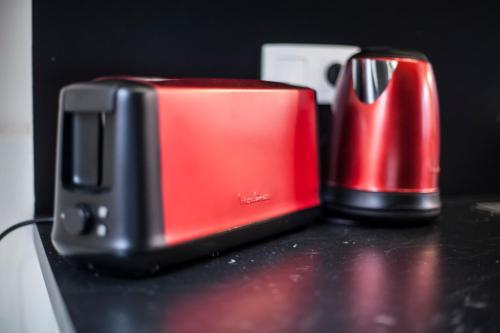 a red and black toaster sitting on a counter at Luxury Suites Grotemarkt by Rikas Hotels in Antwerp