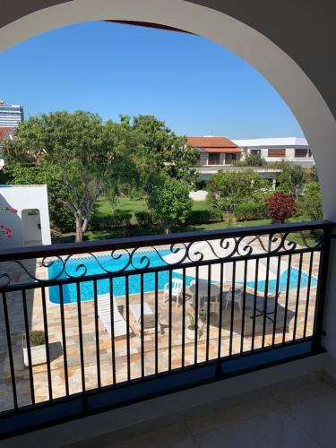 a balcony with a view of a swimming pool at Pousada Santa Fé in Aparecida