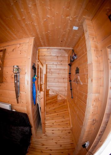 a circular staircase in a wooden cabin with wooden walls at Kedra Village in Kédra