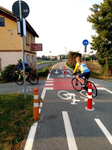 two people riding bikes on a road at Binario 9 3/4 in Villafranca Piemonte