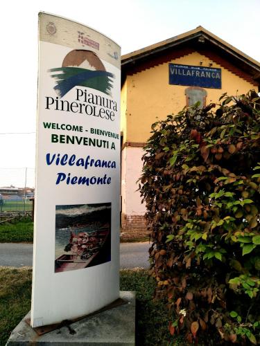 a sign in front of a building with a bush at Binario 9 3/4 in Villafranca Piemonte