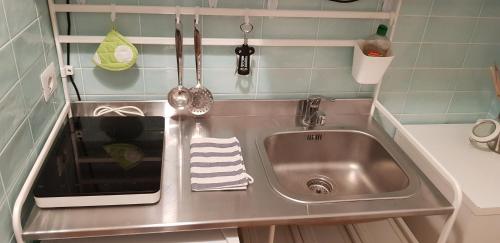 a stainless steel sink in a small kitchen at La Casa di Nonna Rosa in Rome