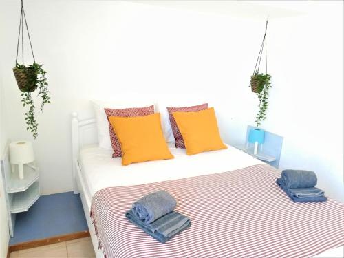 a bedroom with a bed with towels on it at Casa Blu Guesthouse - Casa de Hospedes in Santa Maria