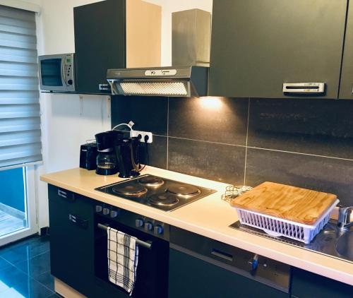 a kitchen with a stove and a counter top at Gästehaus Don Camillo in Ensdorf