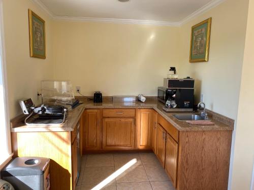 a small kitchen with a sink and a counter top at Deluxe Inn Hardeeville in Hardeeville