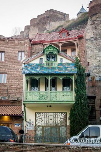 a building with a balcony on top of it at AIA Apartment in Kutaisi