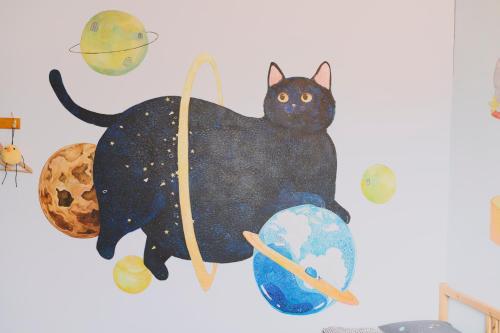 a painting of a black cat on a wall at Red Letter Day in Tainan
