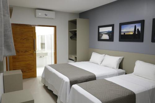 Giường trong phòng chung tại Hotel Barreto