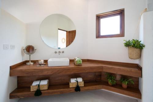 a bathroom with a sink and a mirror at Villas HM Palapas del Mar in Holbox Island
