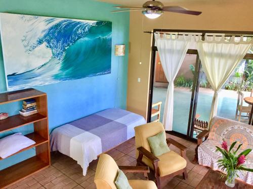 a bedroom with a bed and a view of the ocean at Santa Teresa Surf Vista Villas in Santa Teresa Beach