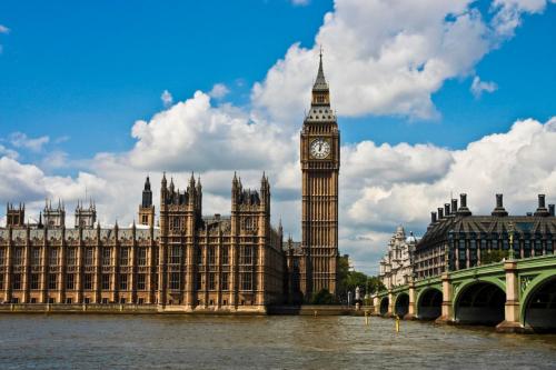 a large building with a clock tower and big ben at Amazing London in London
