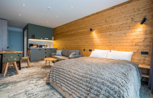 a bedroom with a large bed and a wooden wall at New Gudauri Atrium 224 in Gudauri
