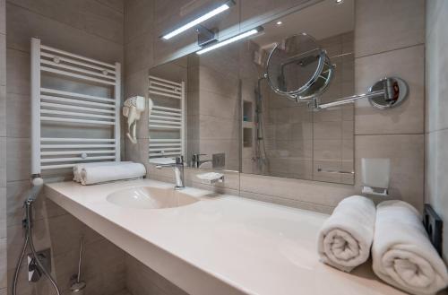 a bathroom with a sink and a mirror at New Gudauri Atrium 224 in Gudauri