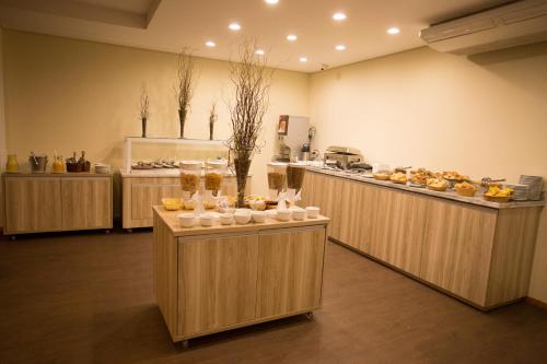 a kitchen with several counters with food on them at Druds Hotel Hortolândia in Hortolândia