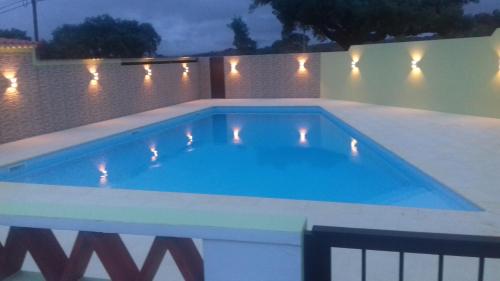 a swimming pool in a backyard at night at Tapada da Beirã in Marvão