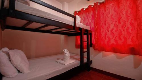 a bedroom with two bunk beds with white towels at NVH2 Coron Palawan in Coron