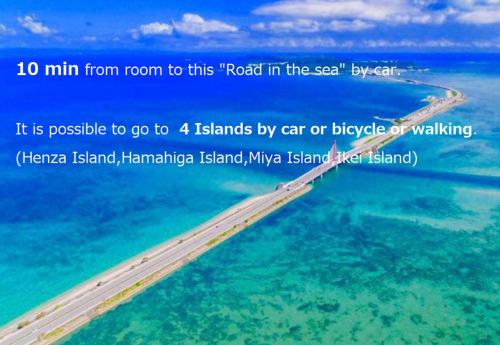 a road in the ocean next to the water at Deluxe Room 130平米 URUMAHOTEL in Uruma