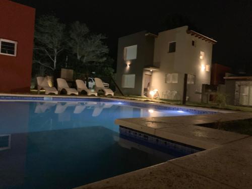 una piscina frente a una casa por la noche en Solar de las Gaviotas en Las Gaviotas