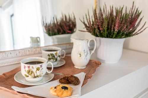 a tray with two cups of coffee and a pastry at Villa Pongina with private pool in Montevarchi