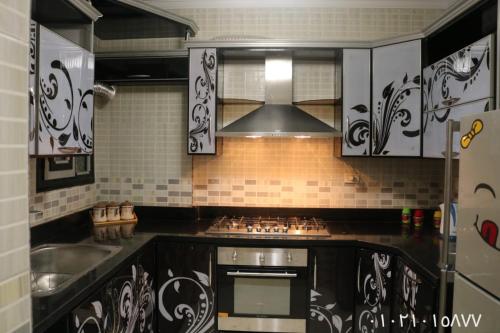 a kitchen with a sink and a stove top oven at Amir flat -ميامي- عائلات فقط in Alexandria