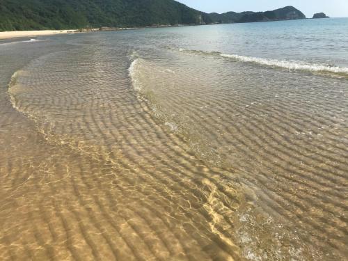 a beach with ripples in the water at Coto Center Homestay in Dao Co To