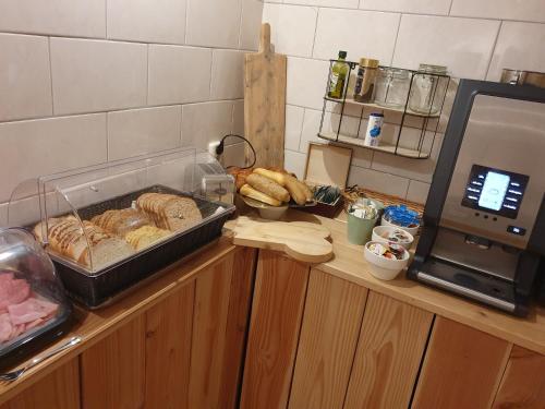 a counter with bread and a tray of bread at City Hotel Meppel in Meppel