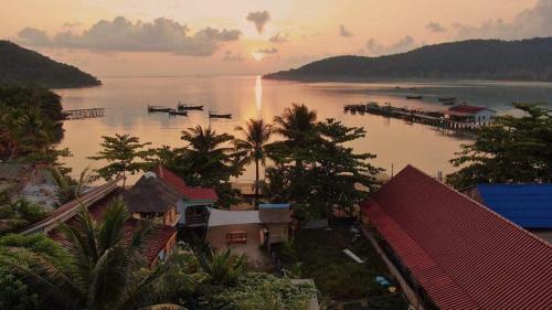 a view of a body of water with houses and boats at Beach House Cambodia in Koh Rong Sanloem