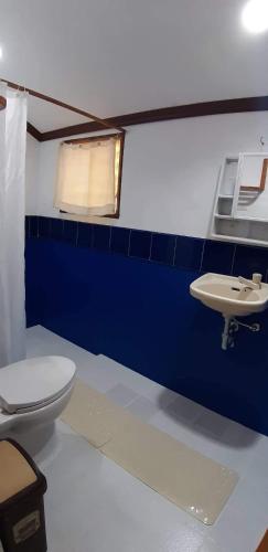 a bathroom with a toilet and a sink at Isla de Paz Beach Resort in Siquijor