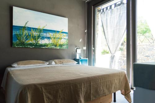 a bedroom with a bed and a large window at Simona Villa - Private Pool in Omignano Scale