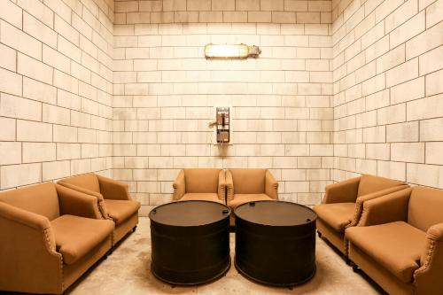 a room with two chairs and a table in the middle at Hotel PaPa Whale in Taipei