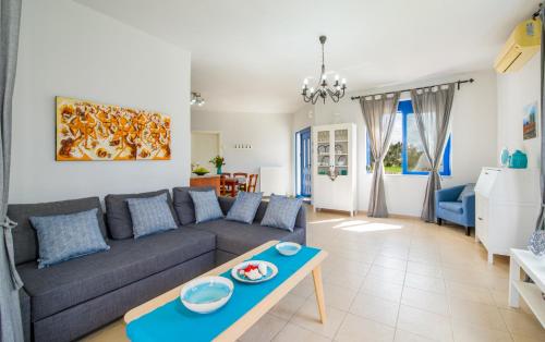 a living room with a couch and a table at Oasea in Tavronitis