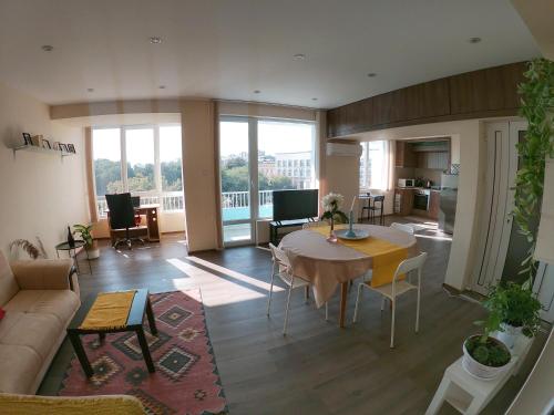 a living room with a table and a couch at By the CATHEDRAL · TOP center · 2 Bedroom FLAT in Varna City