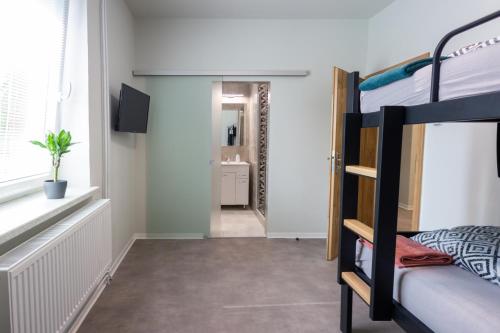 a bedroom with a bunk bed and a hallway at Penzion Moon in Ostrava