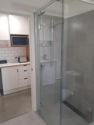 baño con ducha y puerta de cristal en Modern, private and close to town., en Albury