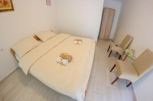 a bedroom with a bed with two boxes on it at Villa Ami in Novi Sad