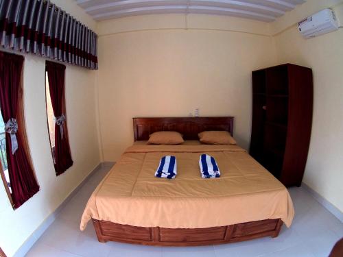 Tempat tidur dalam kamar di Golo Tango Homestay