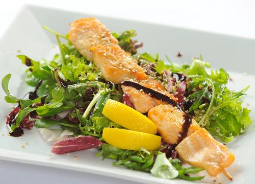 a white plate of food with a salad and fruit at Congress & Wellness Hotel Olsanka in Prague