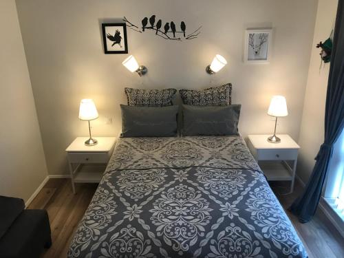 um quarto com uma cama grande e 2 candeeiros em Sigga’s home em Hveragerði