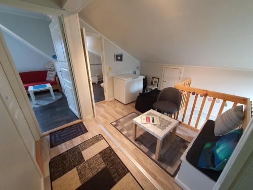 an overhead view of a living room with a couch and a table at 1 Room in The Yellow House, close to Airport & Lofoten in Evenskjer