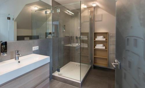a bathroom with a glass shower and a sink at Gasthof Badl - Bed & Breakfast in Hall in Tirol