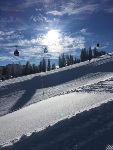a shadow of a person riding a ski lift in the snow at Tom's Alpenhütte in Jenig